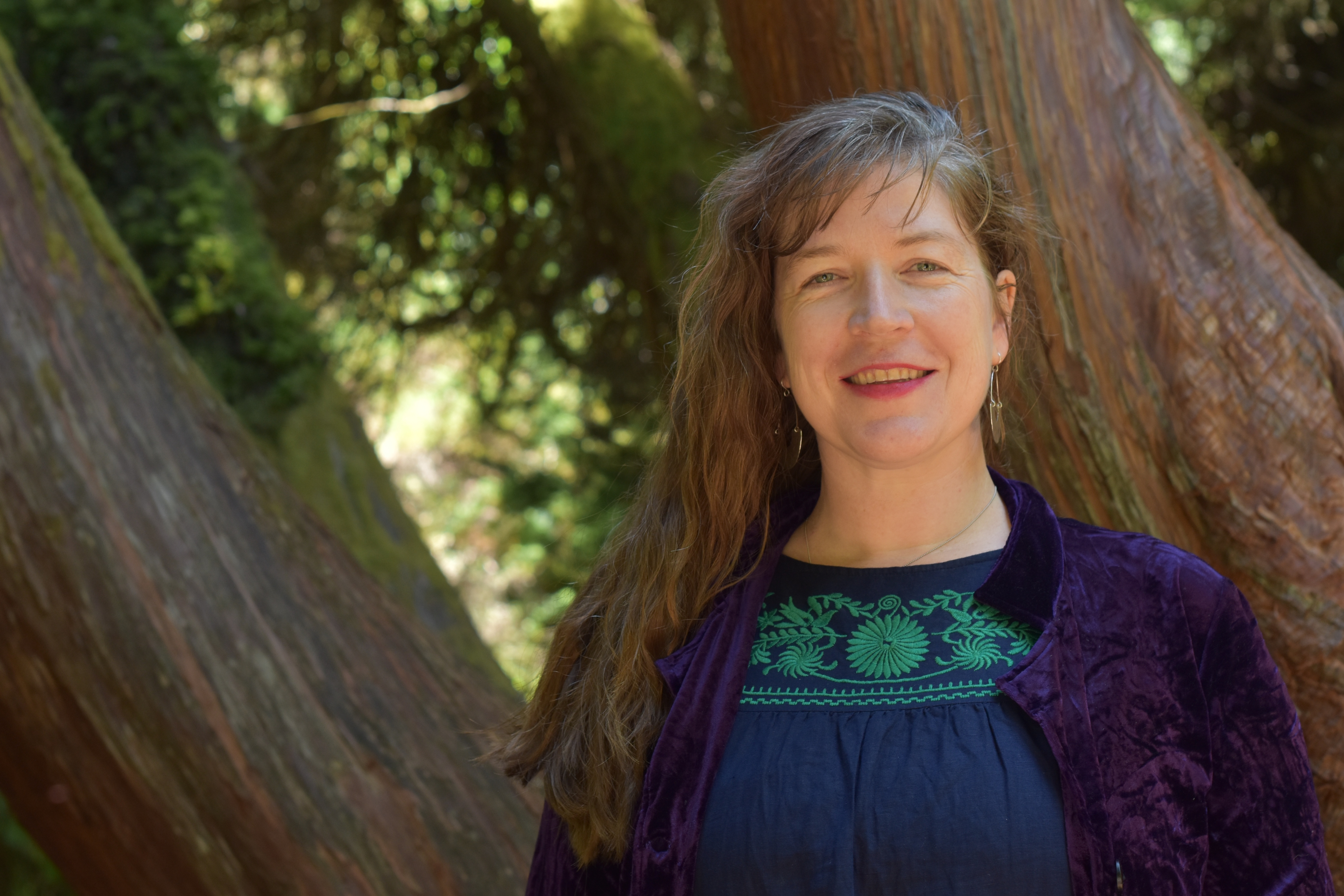 Picture of Sarah with tree behind.